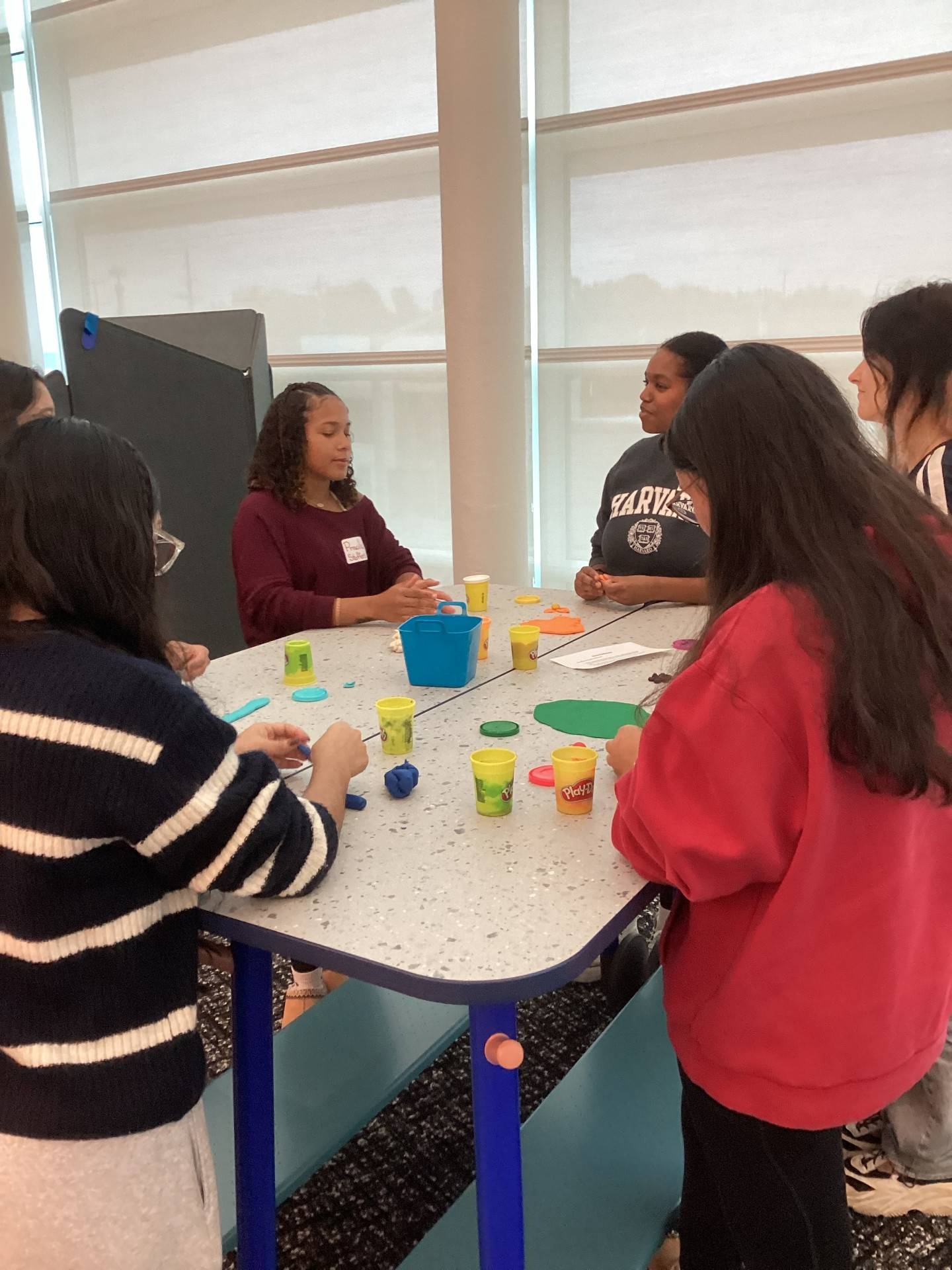 School students engage in group activity with Play-Doh